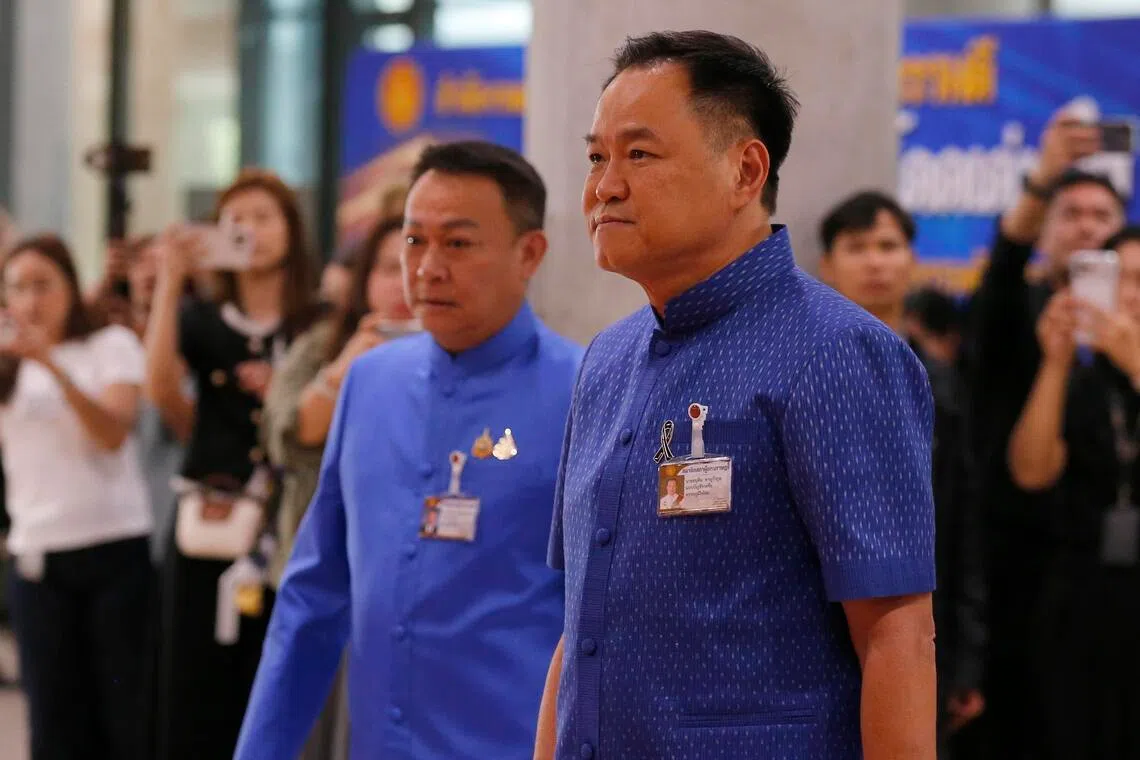 Thai caretaker Prime Minister and Bhumjaithai Party's leader Anutin Charnvirakul (right) arriving for the first meeting to vote for the new Speaker of the House of Representatives of Parliament, in Bangkok on March 15, 2026. 