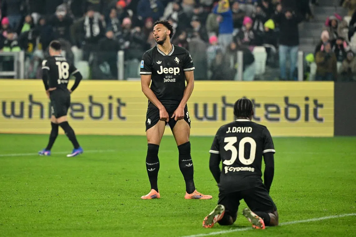 Soccer Football - Serie A - Juventus v Lecce - Allianz Stadium, Turin, Italy - January 3, 2026 Juventus' Jonathan David and Lloyd Kelly react REUTERS/Alberto Lingria