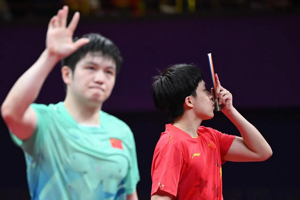 China's Wang Chuqin kissing his bat after beating countryman Fan Zhendong in the Hangzhou Asian Games men's singles final on Oct 2, 2023.