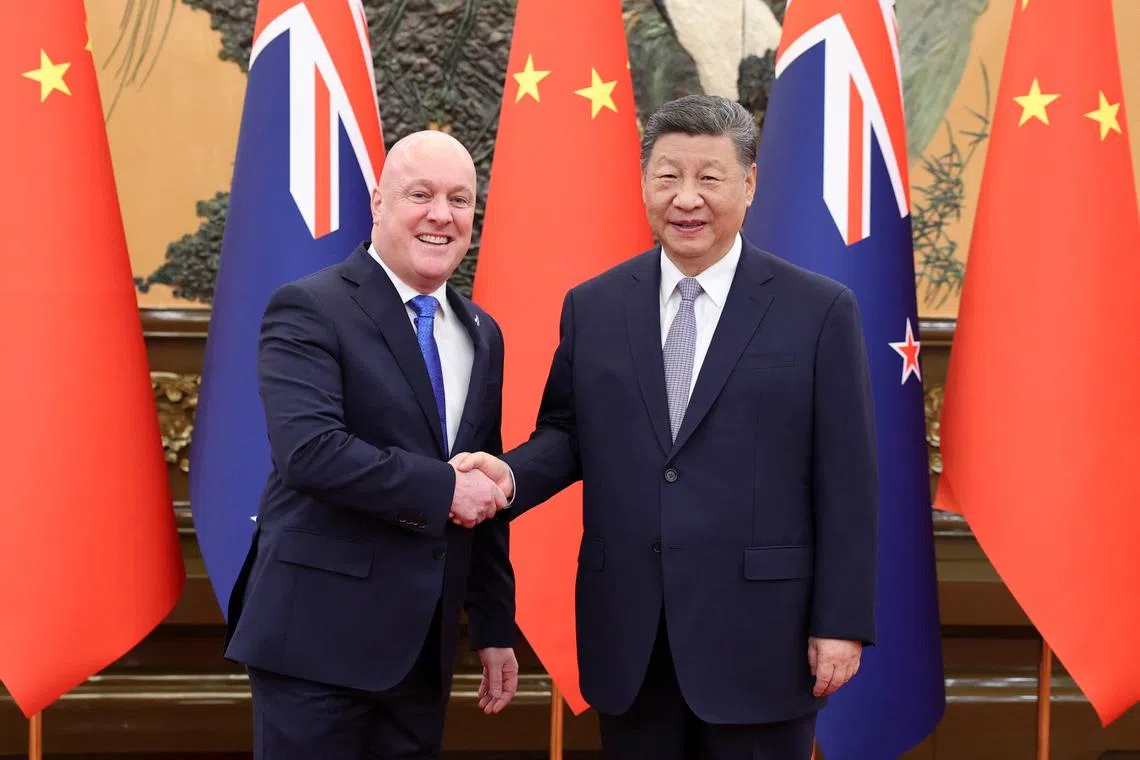 Chinese President Xi Jinping and New Zealand's Prime Minister Christopher Luxon shake hands at the Great Hall of the People in Beijing, China June 20, 2025. China Daily via REUTERS