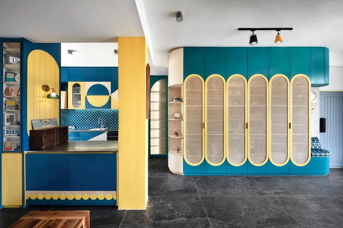 The bold yellow and blue palette of this walk-up apartment is a far cry from the original monochromatic interior.