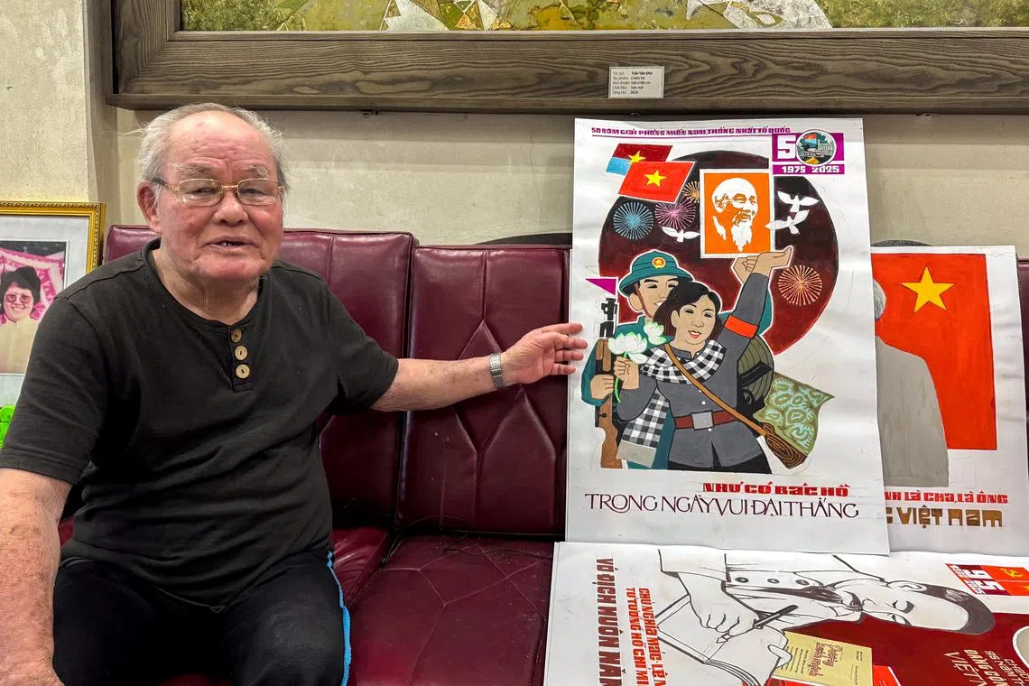 Artist Tran Duy Truc, 82, gestures next to a propaganda painting ahead of the 50th anniversary of Vietnam’s Liberation Day, in Hanoi, Vietnam, April 29, 2025. REUTERS/Phuong Nguyen