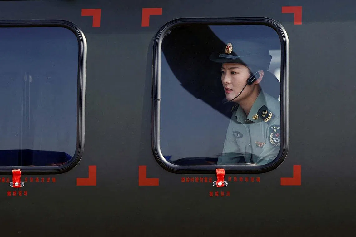 A member of the Chinese People's Liberation Army (PLA) sitting in a Z-20 helicopter, at the China International Aviation and Aerospace Exhibition, also known as Airshow China, in Zhuhai, Guangdong province, China, Nov 12, 2024. 