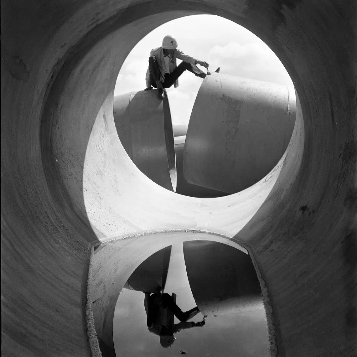 Worker Through Concrete Pipe At Construction Site by Foo Tee Jun. 