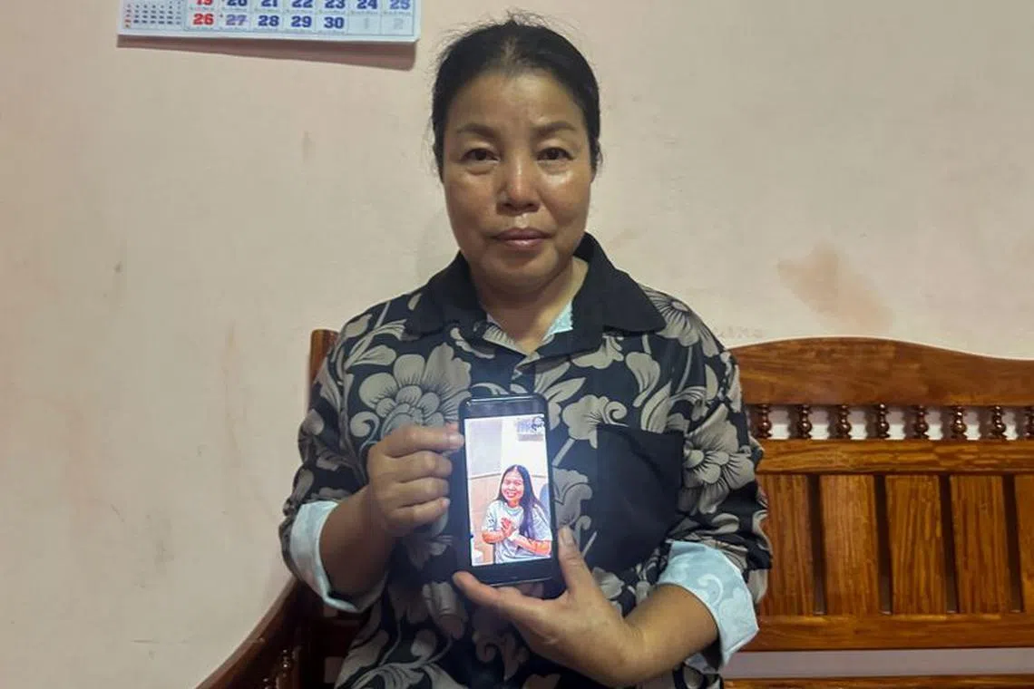 The mother of a Thai hostage released as part of a hostages-prisoners swap deal between Hamas and Israel holds her phone showing an image of her daughter on Nov 25, 2023. REUTERS/Napat Wesshasartar