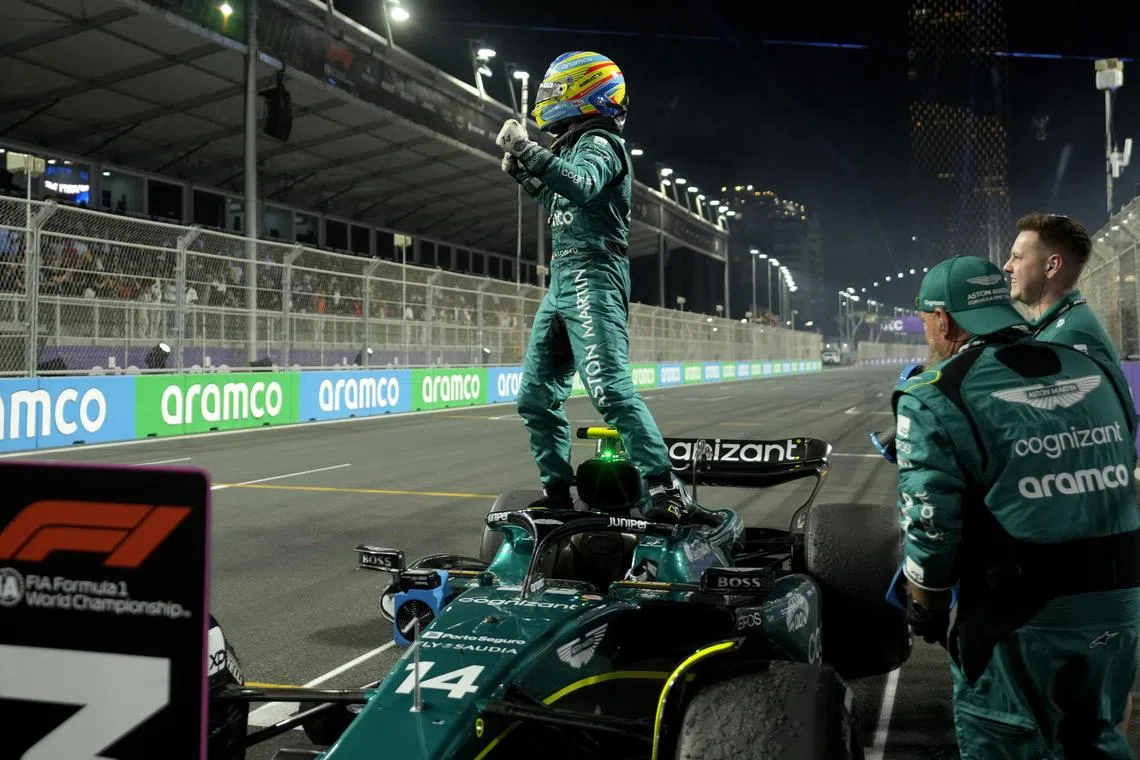 Aston Martin's Fernando Alonso celebrating after placing third in the Saudi Arabia Grand Prix at the Jeddah Corniche Circuit.