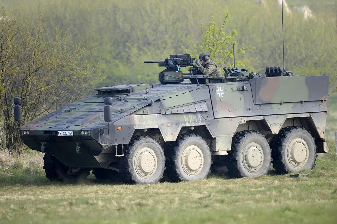 FILE PHOTO: A German soldier reloads a heavy machine gun of an armoured fighting vehicle Boxer during a presentation of German army Bundeswehr in Putlos, April 25, 2012. REUTERS/Fabian Bimmer/File Photo