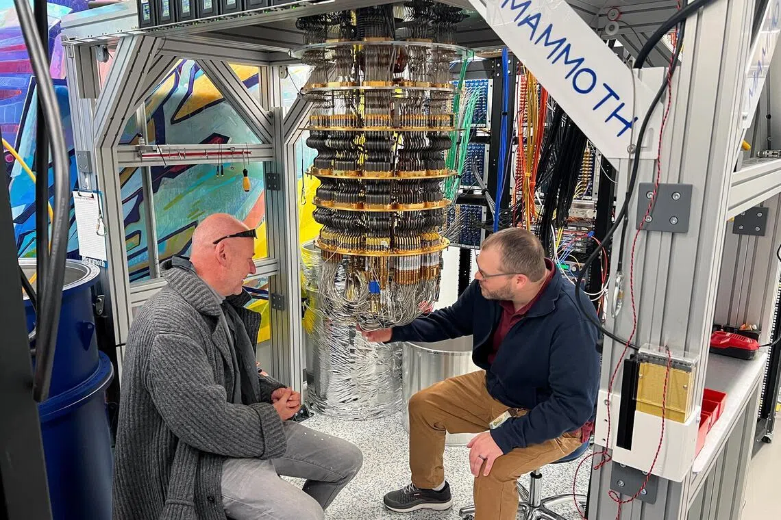 Google Quantum AI's Hartmut Neven (L) and Anthony Megrant (R) examine a cryostat refrigerator for cooling quantum computing chips at Google's Quantum AI lab in Santa Barbara, California, U.S. November 25, 2024. REUTERS/Stephen Nellis