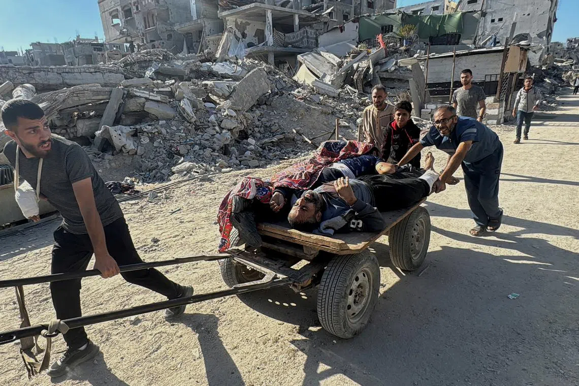 Palestinians assist casualties following an Israeli strike, amid the Israel-Hamas conflict, in Beit Lahiya in the northern Gaza Strip October 30, 2024. REUTERS/Stringer=