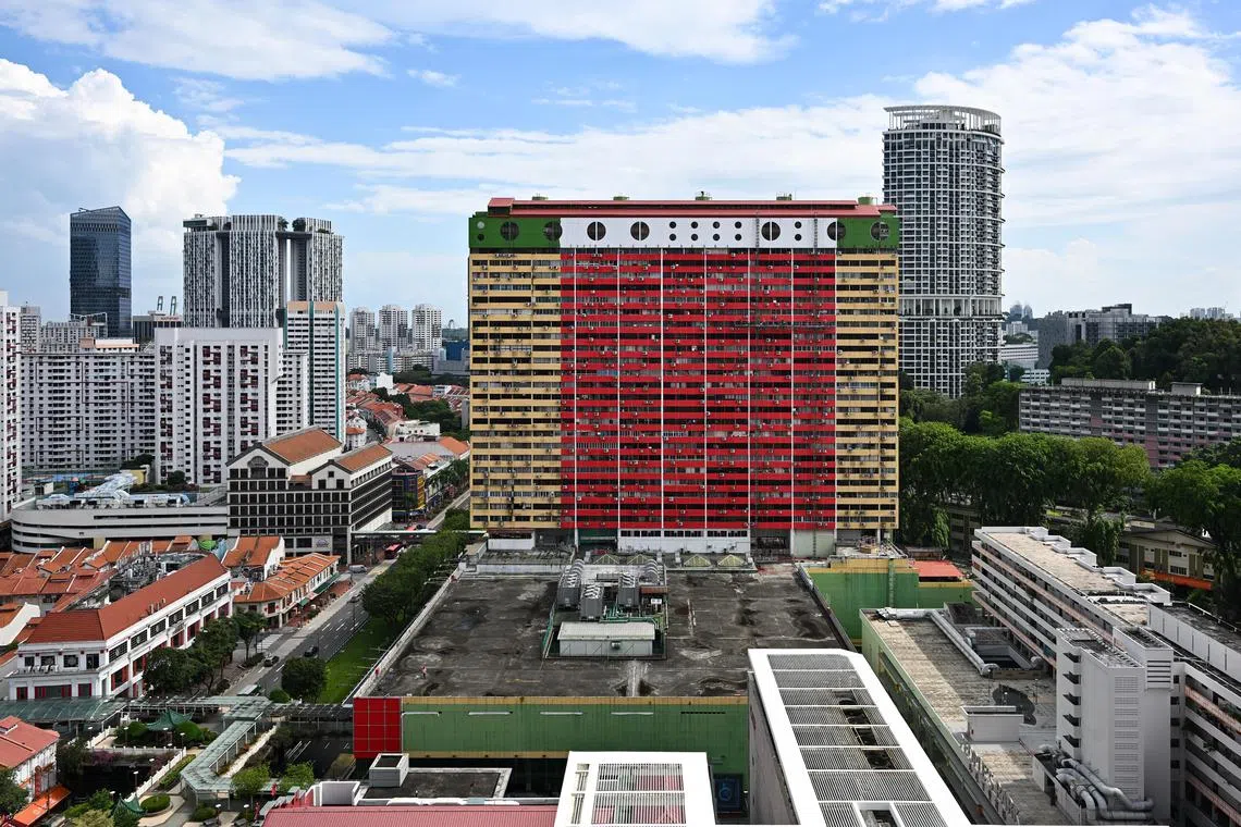 ST20250520-202524400190-Lim Yaohui-pixgeneric People's Park Complex in Chinatown being repainted in red and white on May 20, 2025. People’s Park Complex is a 31-storey 99 years leasehold mixed residential and commercial building. The commercial part was built in 1970 whereas the residential block was built in 1973. It is situated in the heart of Chinatown at 1 Park Road Singapore 059108 in district 01. The commercial space is primarily used for office, F&B and retails shops sale and rental. (ST PHOTO: LIM YAOHUI)