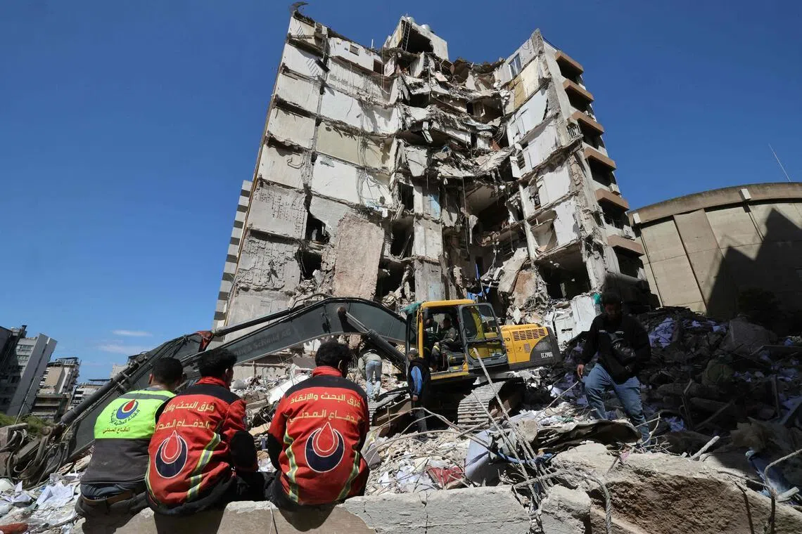 Lebanese rescuers clear the rubble at the site of an Israeli airstrike that targeted a building the day before in Beirut on April 9, 2026. 