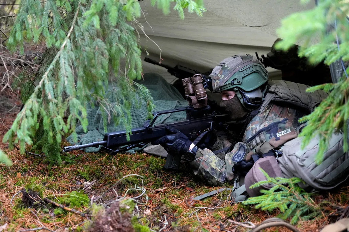 A German Defence forces serviceman guards a hide and antenna for lightweight detection system for electromagnetic spectrum during Viligant Owl media day in Paluknys air field, Lithuania October 28, 2026. REUTERS/Ints Kalnins