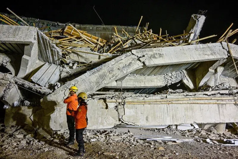 Rescue personnel inspect the site after a building collapsed at an Islamic boarding school in Sidoarjo, East Java on Sept 29, 2025.