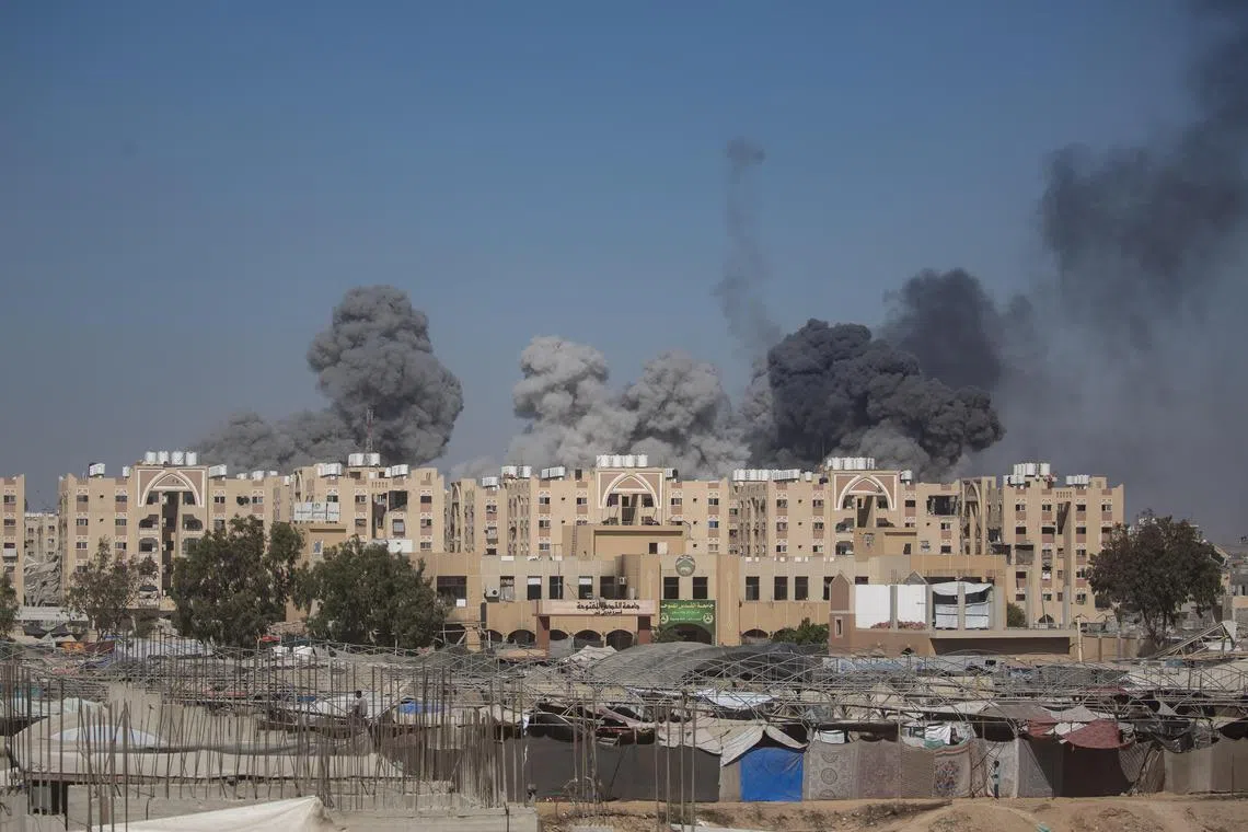 Displaced Palestinians flee amid Israeli shelling in Khan Younis, in the southern Gaza Strip, on Aug 16.
