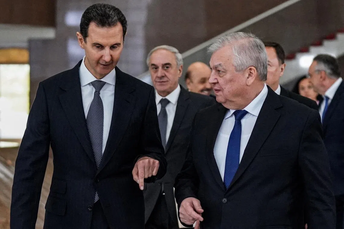 Syria's President Bashar al-Assad (left) receiving Russia's Special Envoy for Syria Alexander Lavrentiev (right).