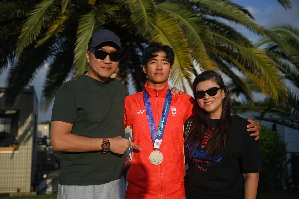 Sailor Ian Goh (centre) pictured with his parents Gary Goh (left) and Grace Tan after the Asian Games sailing events at the Kaiyoh Yacht Harbour on Oct 3, 2026.