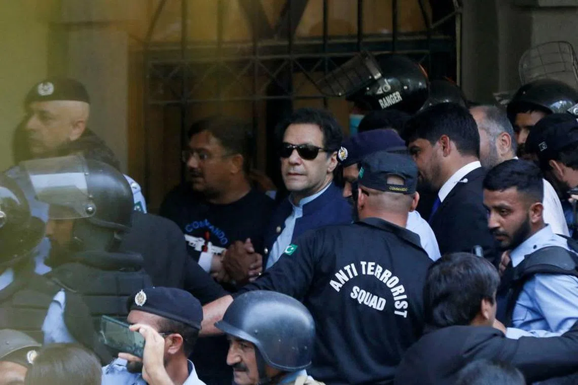FILE PHOTO: Security officers escort Pakistan's former Prime Minister Imran Khan, as he appeared in Islamabad High Court, Islamabad, Pakistan May 12, 2023. REUTERS/Akhtar Soomro/File Photo