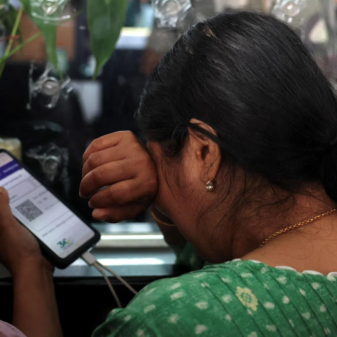 A traveller reacts after her IndiGo flight was cancelled, outside Kempegowda International Airport in Bengaluru, India on Dec 5, 2025.