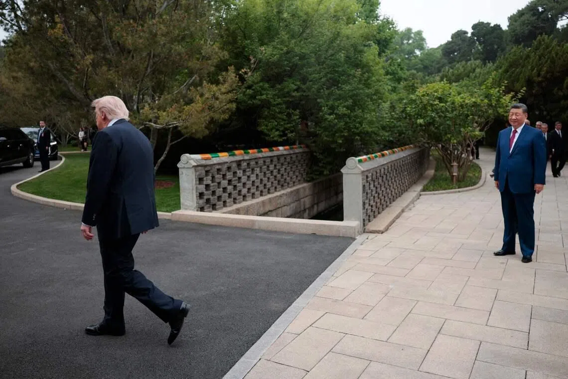 US President Donald Trump (left) walking towards his car as China’s President Xi Jinping (right) watches following a visit to Zhongnanhai Garden in Beijing on May 15.