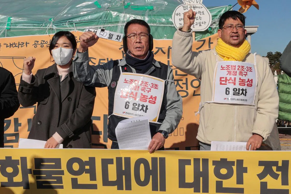 Protesters chant slogans at a news conference in support of the ongoing strike by truckers in Seoul, South Korea December 5, 2022.  Yonhap via REUTERS ATTENTION EDITORS - THIS IMAGE HAS BEEN SUPPLIED BY A THIRD PARTY. SOUTH KOREA OUT. NO RESALES. NO ARCHIVES.