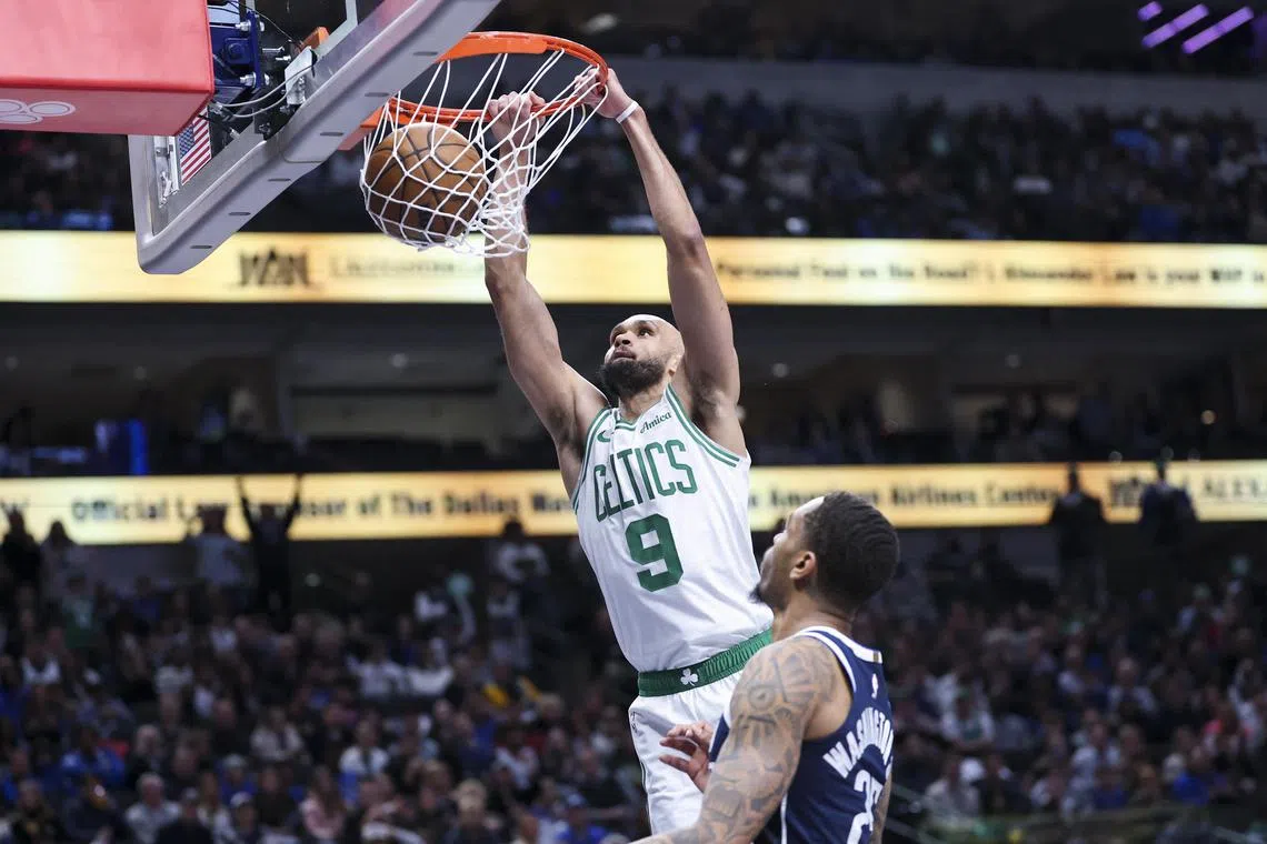 Boston Celtics guard Derrick White dunking over Dallas Mavericks forward P.J. Washington during the second half at American Airlines Centre on Jan 25. White scored 23 points in his team's 