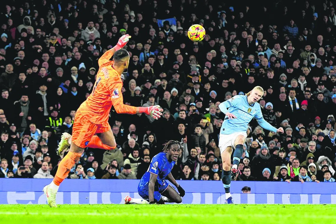 Manchester City's Erling Haaland scoring past Chelsea goalkeeper Robert Sanchez in January 2025.