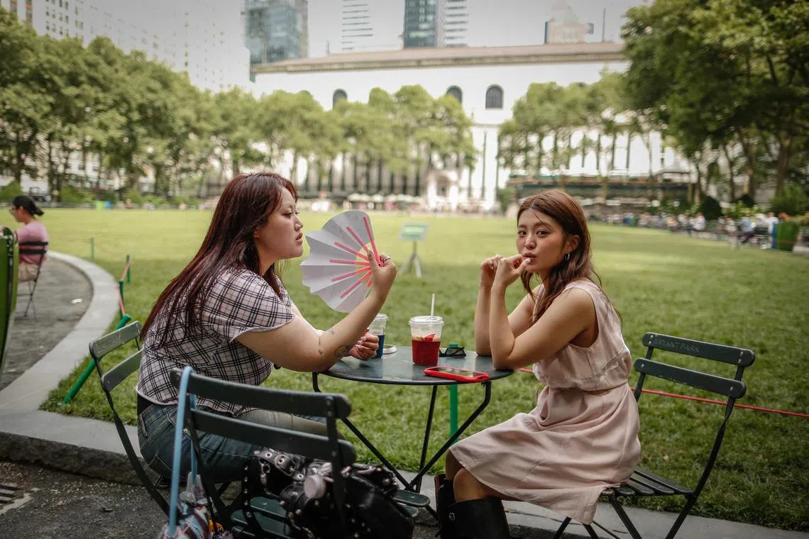 A woman holds a fan during a heat wave in New York City, on June 22, 2025. 