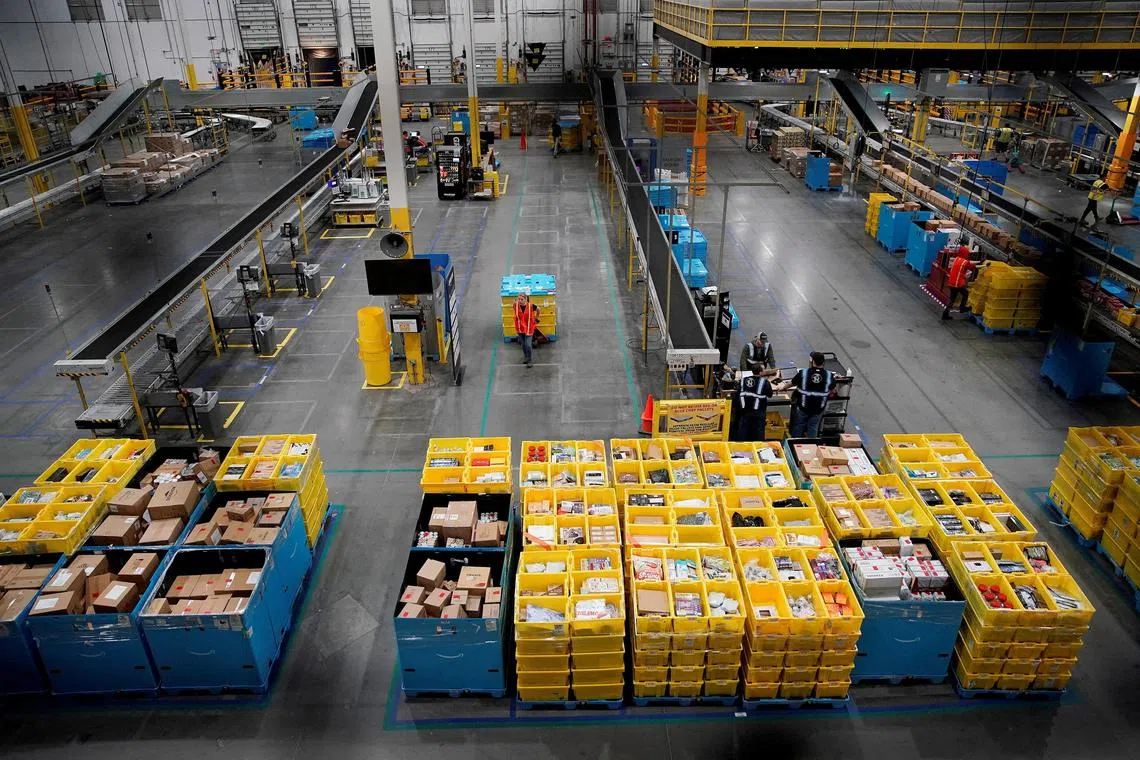 FILE PHOTO: Workers select and pack items during Cyber Monday at the Amazon fulfilment center in Robbinsville Township in New Jersey, U.S., November 28, 2022. REUTERS/Eduardo Munoz/File Photo