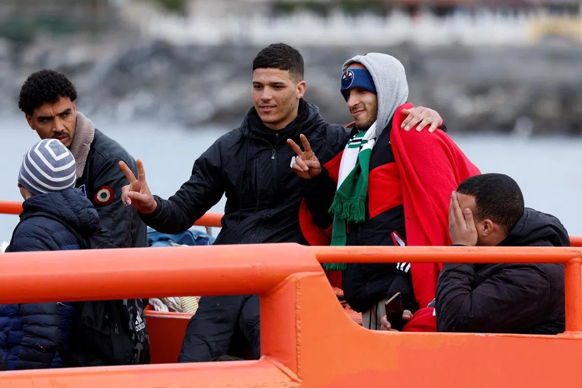 Migrants wait to disembark at a port in Spain, after being picked up by the Spanish coast guard, on Jan 31, 2023.