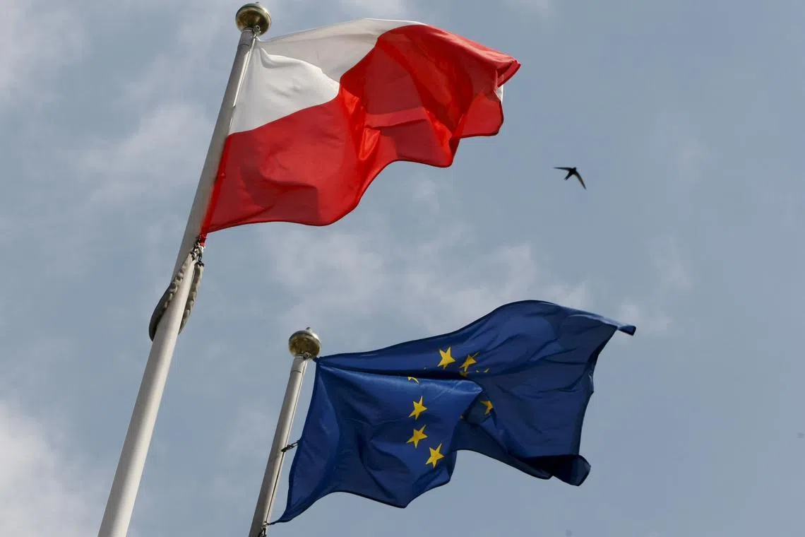 The flags of Poland and European Union flutter in front of the Polish parliament in Warsaw June 29, 2011. REUTERS/Kacper Pempel/File Photo