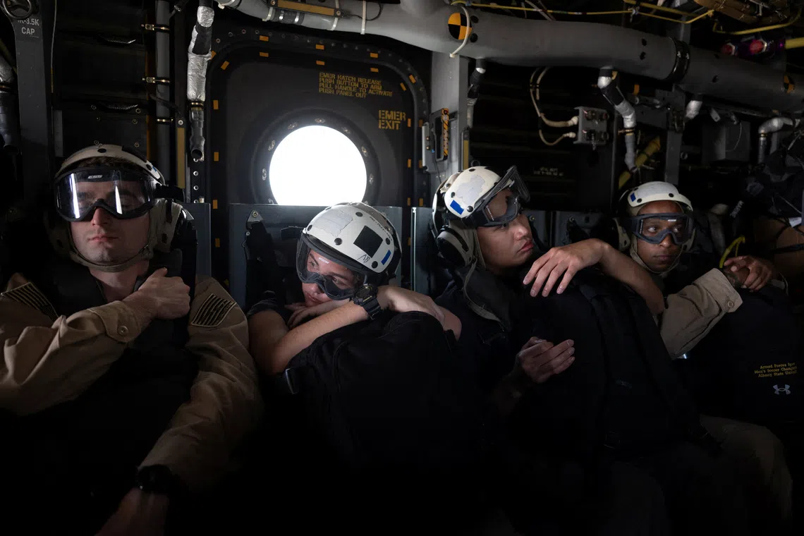 US Navy sailors aboard an MV-22 Osprey travel to the Nimitz-class aircraft carrier USS George Washington in the Arabian Sea, September 11, 2026. The aircraft carrier, capable of carrying more than 5,000 personnel, is enforcing a US naval blockade against Iran and providing cover for commercial vessels transiting the Strait of Hormuz.  REUTERS/Ed Ou
