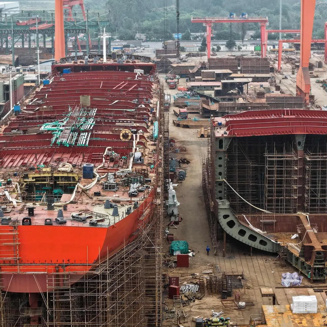 This aerial view shows ships under construction at a shipbuilding facility along the Yangtze River in Yangzhou, east China's Jiangsu province, on October 14, 2025. (Photo by -STR / AFP) / China OUT