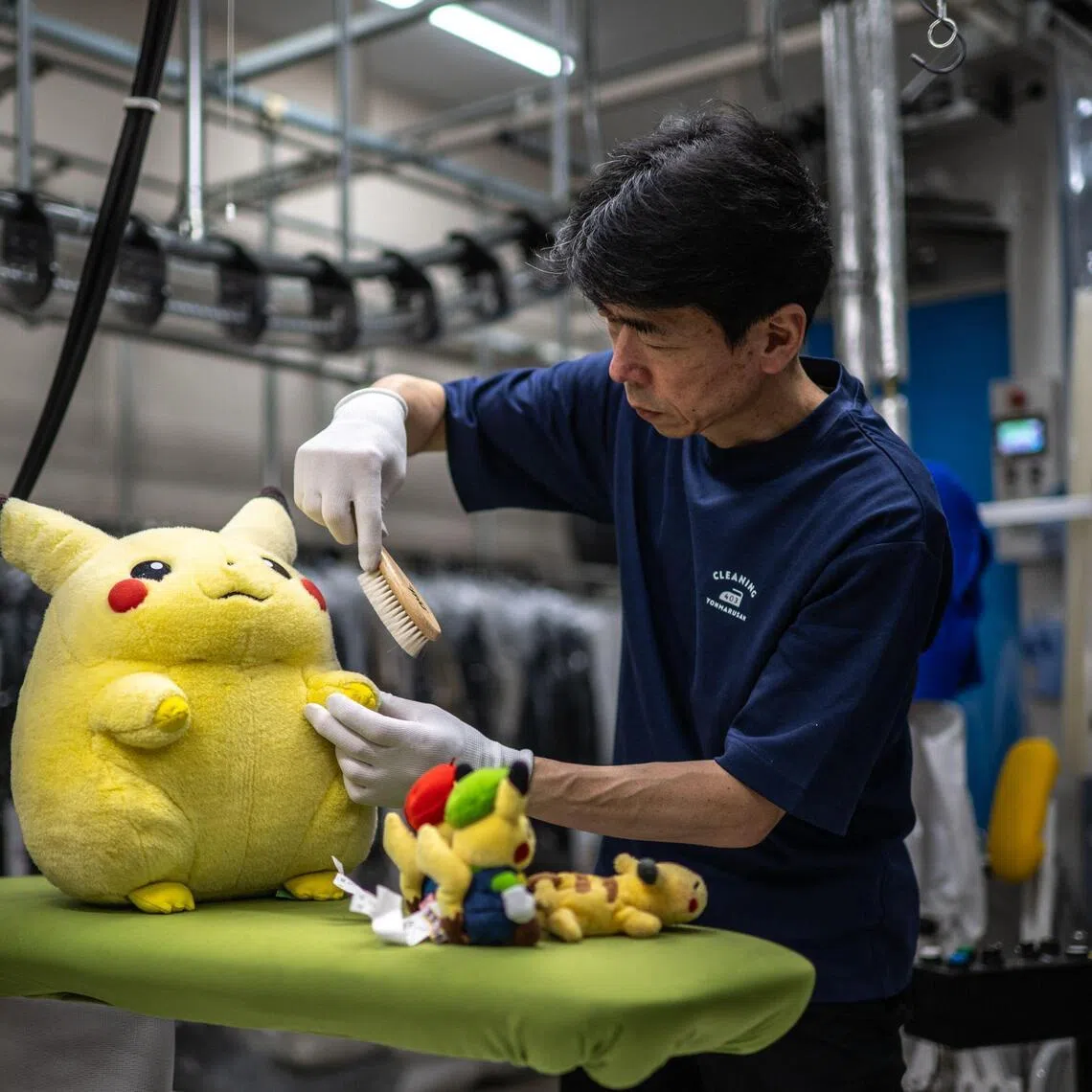 Dry-cleaning professional Masakazu Shimura brushes a soft toy at the facility of Cleaning Yonmarusan in Fuefuki city of Yamanashi Prefecture.