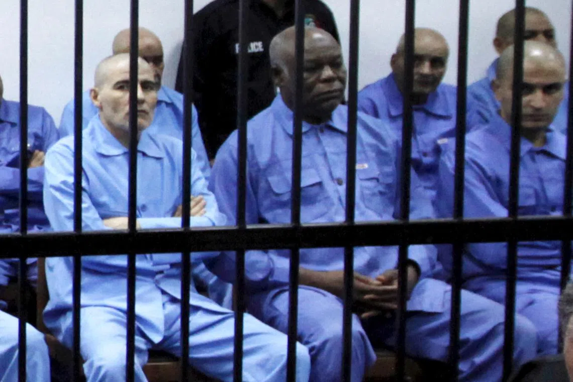 FILE PHOTO: Abu Agila Mohammad Mas'ud Kheir Al-Marimi (second from left) at a courtroom in Tripoli November 16, 2014. 