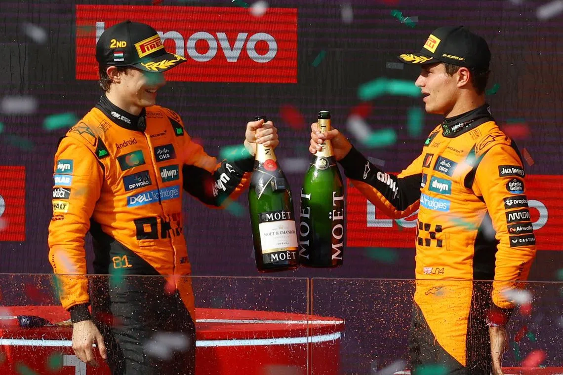 Formula One F1 - Hungarian Grand Prix - Hungaroring, Budapest, Hungary - August 3, 2025 McLaren's Lando Norris celebrates on the podium after winning the Hungarian Grand Prix with second placed McLaren's Oscar Piastri REUTERS/Bernadett Szabo