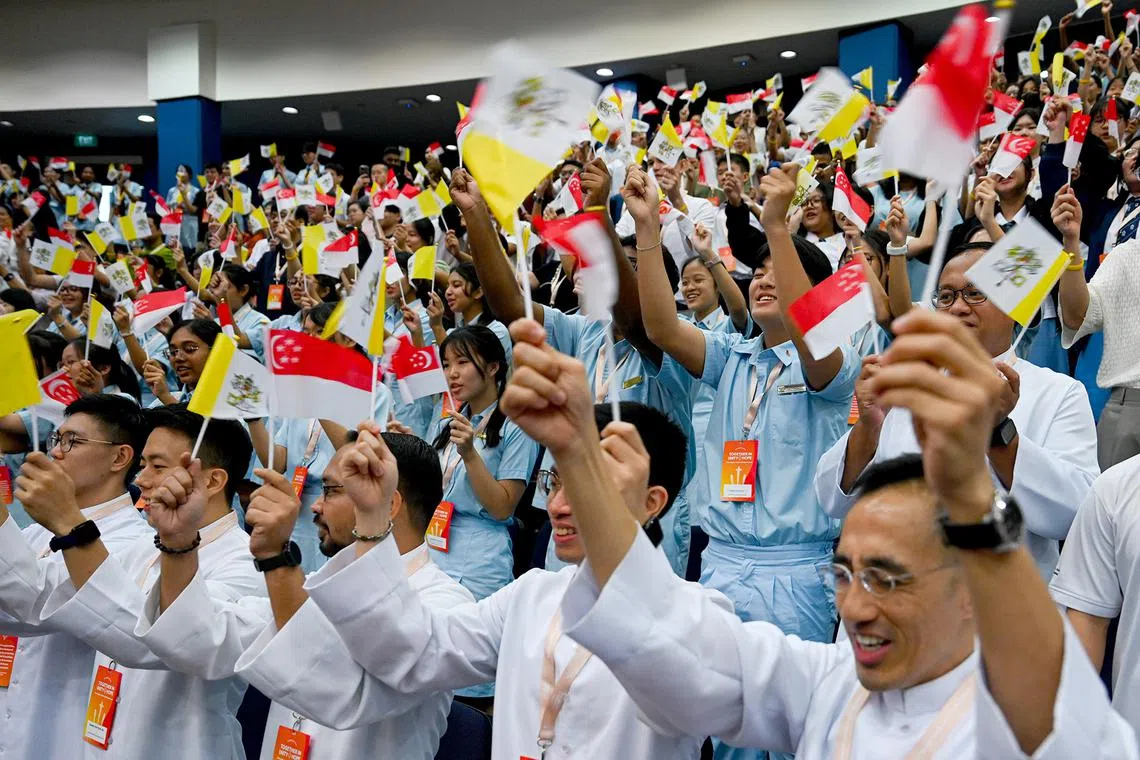 Audience greets Pope Francis at the Interfaith Dialogue held at Catholic Junior College Auditorium, September 13, 2024.