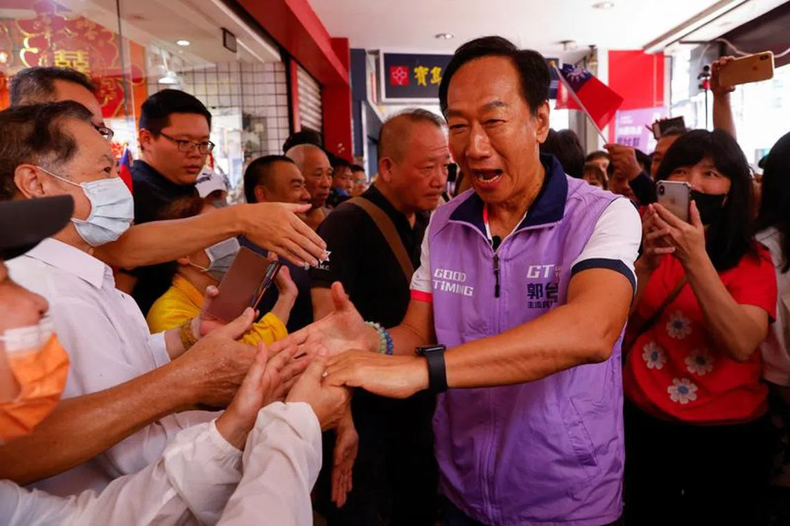 Foxconn founder Terry Gou shakes hands with his supporters at one of his signature campaign offices in New Taipei City, Taiwan September 20, 2023. REUTERS/Ann Wang/ File Photo
