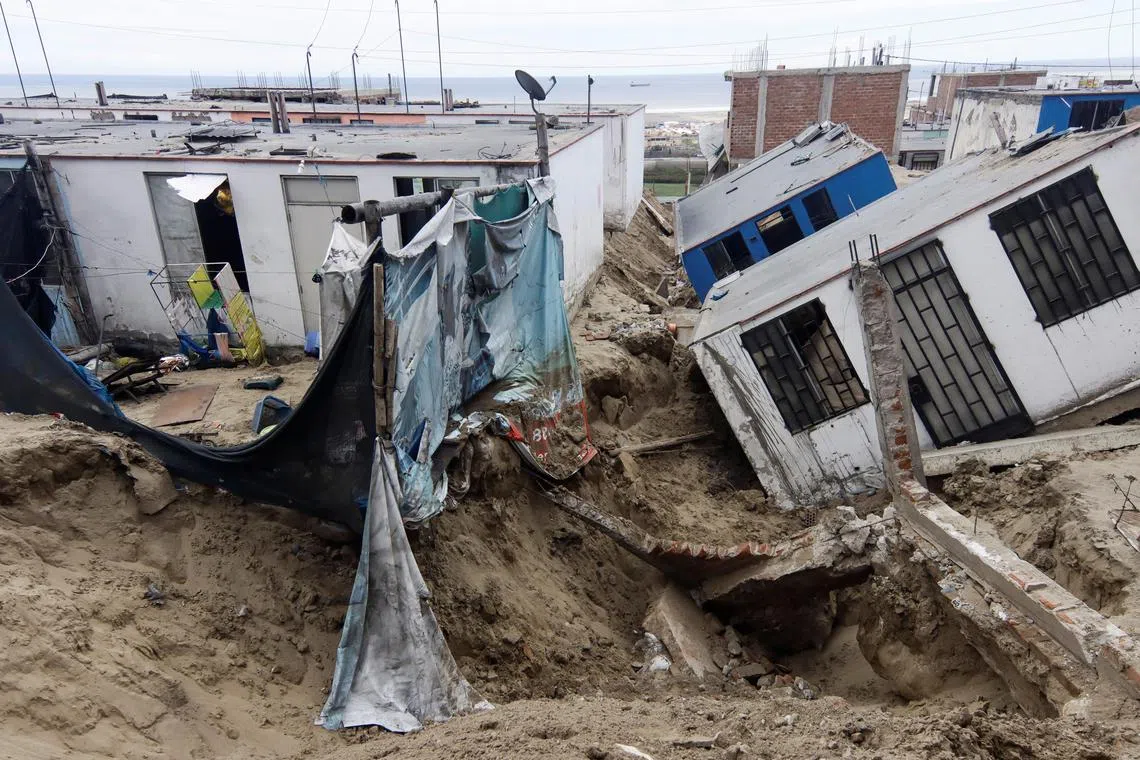 View of damaged houses in the aftermath of the Moche river overflowing due to torrential rains caused by Cyclone Yaku, in Trujillo, Peru, on March 13, 2023. 