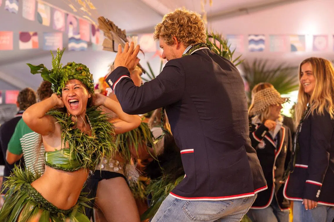 Paris 2024 Olympics - Opening Ceremony - Teahupo'o, French Polynesia - July 26, 2024. John John Florence of United States dances with local performers during the opening ceremony of the Olympic Games Paris 2024   Ed Sloane/Pool via REUTERS