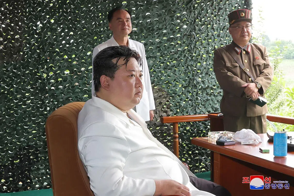 North Korean leader Kim Jong Un attending the test firing of a new intercontinental ballistic missile (ICBM) "Hwasong-18" at an undisclosed location in North Korea, on July 12, 2023. On the table was a foldable phone.