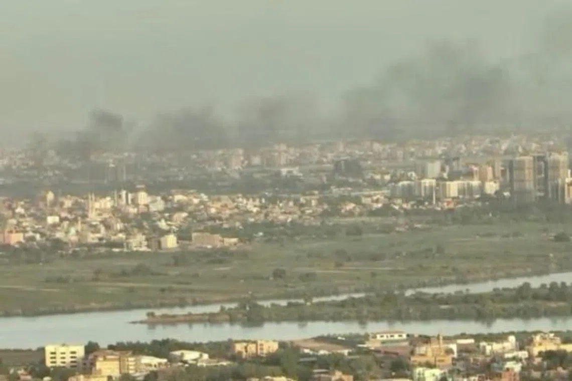 FILE PHOTO: A drone view shows smoke rising over buildings a week after fighting began in North Khartoum, as seen from Omdurman, Sudan, April 22, 2023, in this still image taken from video obtained by Reuters. Reuters TV via REUTERS
