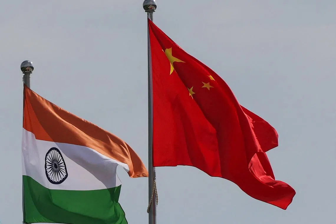 The national flags of India and China seen outside the Tianjin Meijiang Convention and Exhibition Centre on Aug 30.