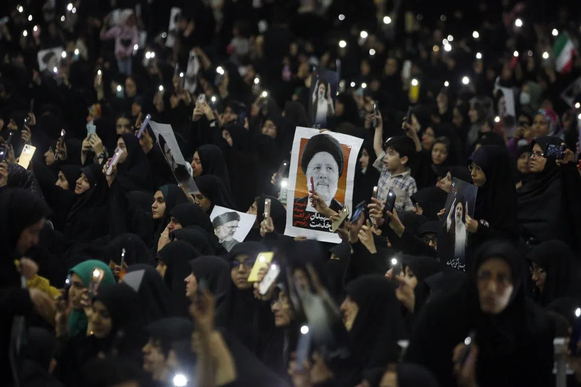 Iranians mourn the late president Ebrahim Raisi during the funeral procession at the Mossallah mosque in Tehran, on May 21.