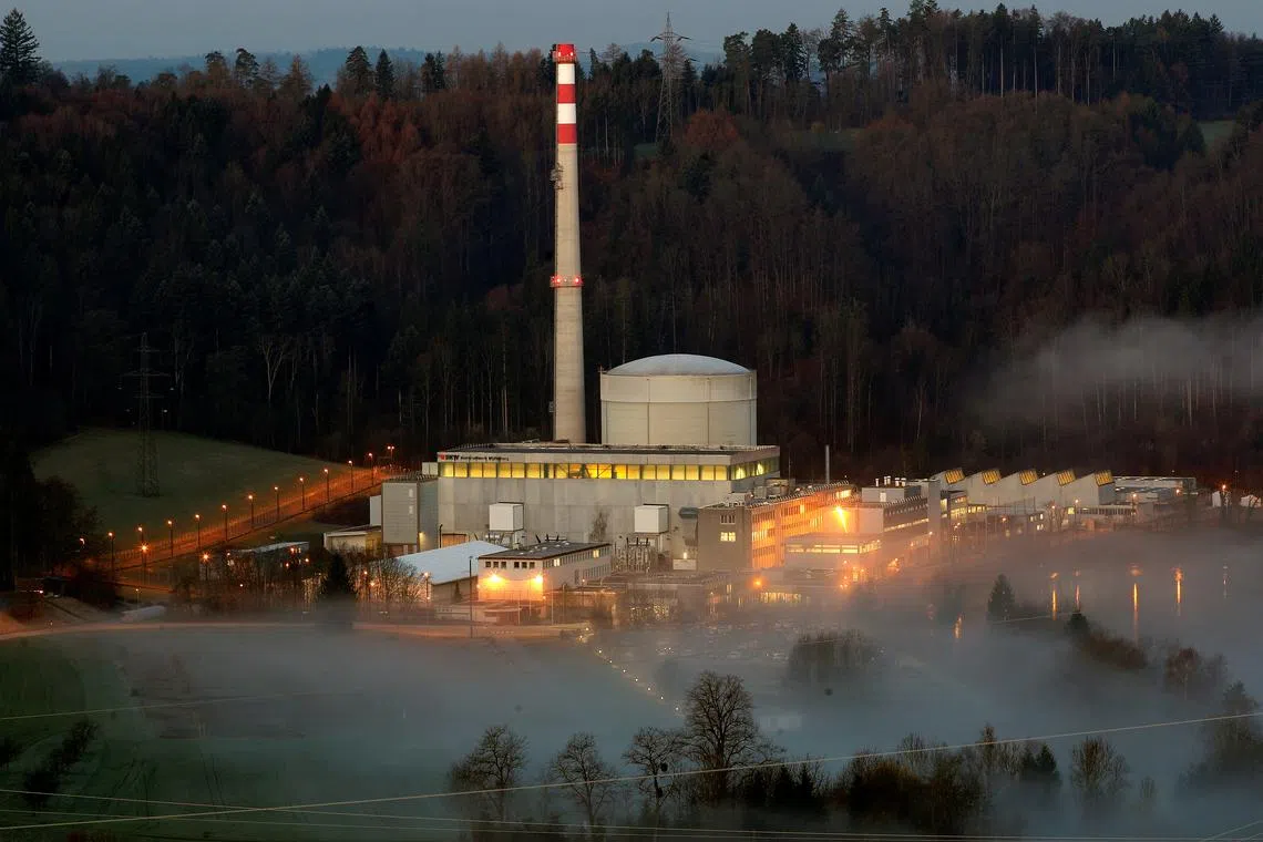 FILE PHOTO: Swiss energy company BKW's Muehleberg nuclear power plant and the fog-covered Aare river are seen in Muehleberg near Bern, Switzerland, April 6, 2018. REUTERS/Arnd Wiegmann/File Photo