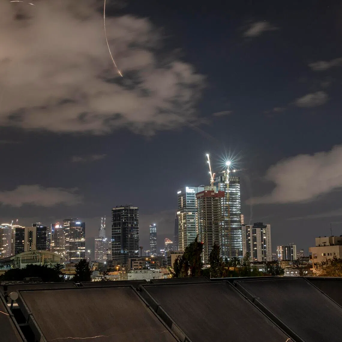 Trails from interceptors glow amid an air raid warning about incoming missiles from Iran in Tel Aviv, Israel, early on March 7.