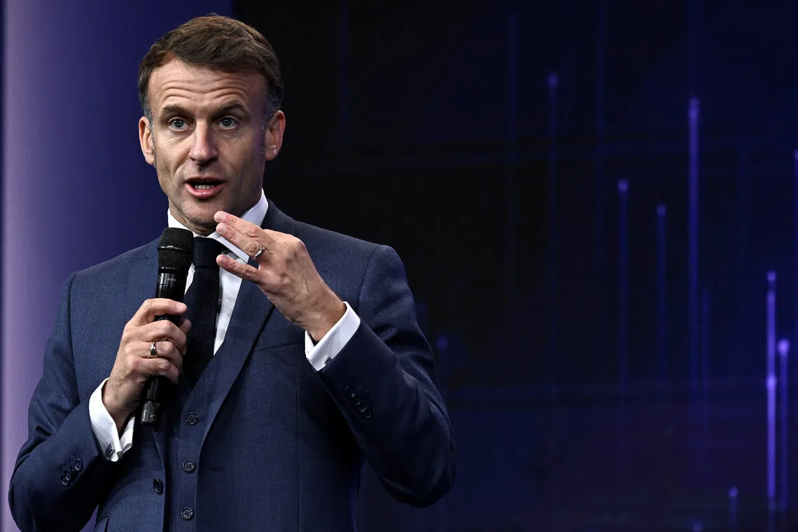 France's President Emmanuel Macron gestures as he speaks during the opening of the \"Adopt AI\" international summit on artificial intelligence, at the Grand Palais in Paris, France November 25, 2025. Julien De Rosa/Pool via REUTERS