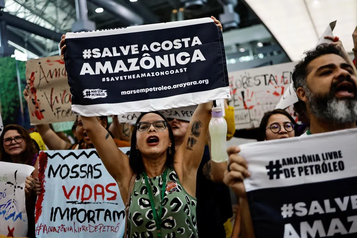 Members of social movements protest against oil exploration in the Amazon, inside the convention center where the Amazon Dialogues Seminar takes place, before a summit of Amazon rainforest nations in Belem, Para state, Brazil August 6, 2023. REUTERS/Ueslei Marcelino