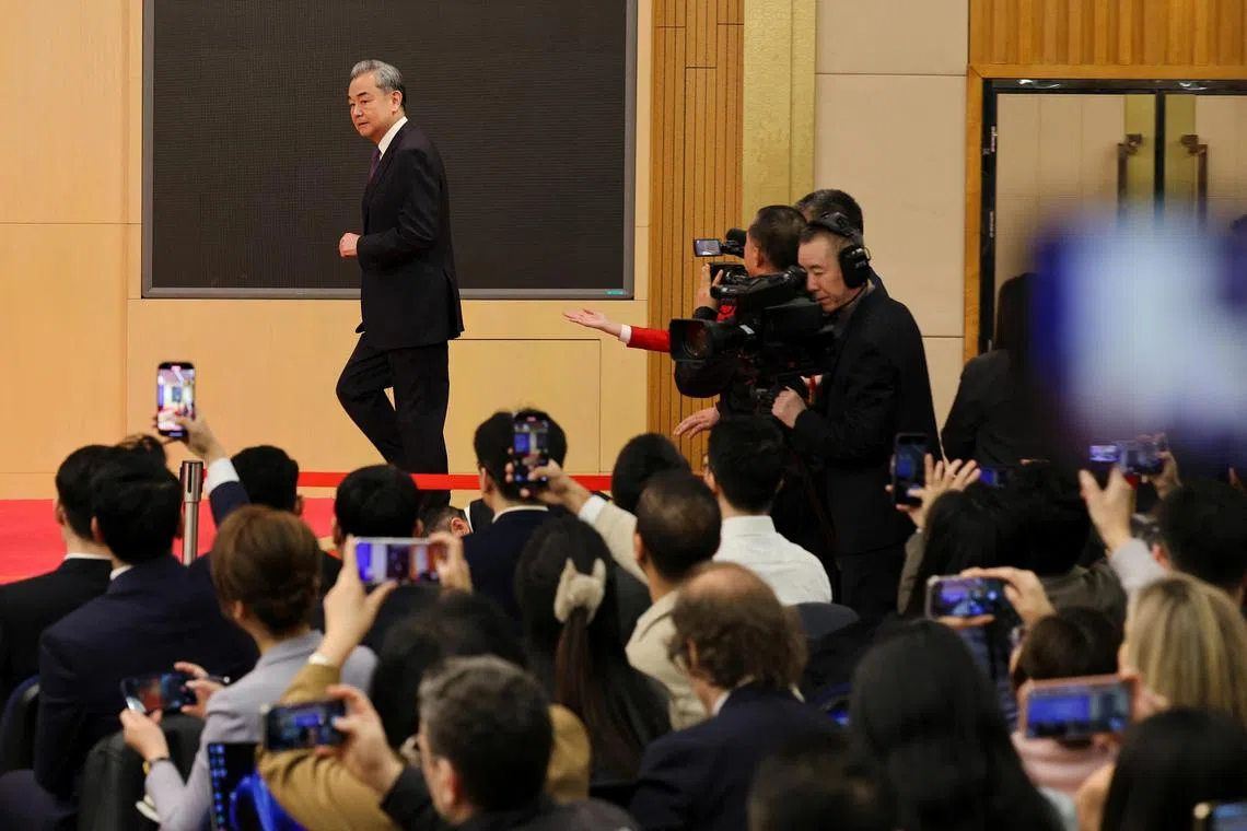 Chinese Foreign Minister Wang Yi walks to attend a press conference on the sidelines of the National People's Congress (NPC) in Beijing, China March 7, 2025. REUTERS/Go Nakamura