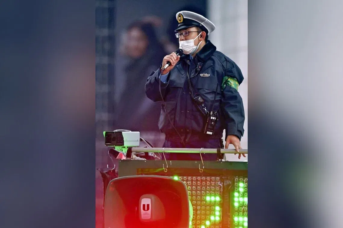 A “DJ police officer” directing the crowds on the streets of Shibuya Ward, Tokyo, in 2022.