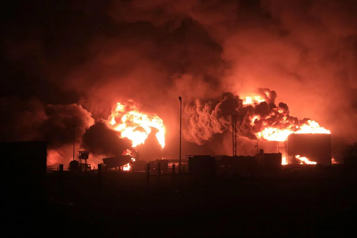 TOPSHOT - A giant fire erupts at an oil storage facility following Israeli strikes in Yemen's Huthi-held port city of Hodeida on July 20, 2024. Israeli warplanes struck the Huthi-controlled Yemeni port of Hodeida on July 20, a day after a drone attack by the Huthi rebels killed a civilian in Tel Aviv, both sides said. (Photo by AFP)